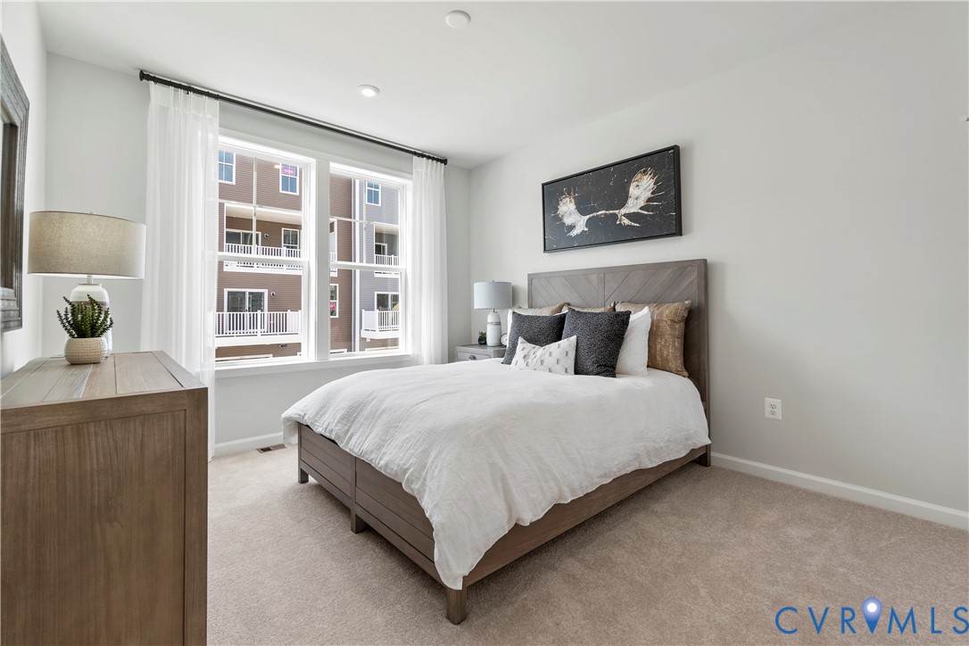 3611 Edna Path, Unit A Richmond, VA 23233 - Photo 20 of 32 a bedroom with a bed lamp and a window