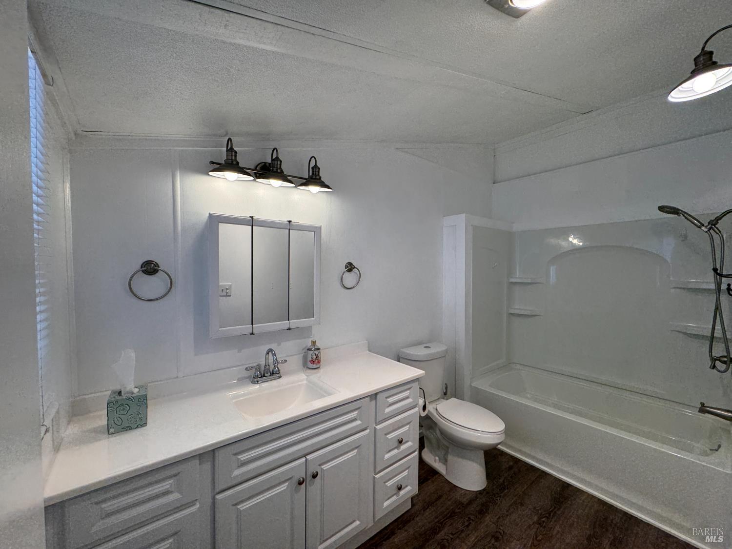 52 Oakstone Court, Unit 52 Santa Rosa, CA 95409 - Photo 23 of 49 a bathroom with a granite countertop toilet sink a mirror and shower