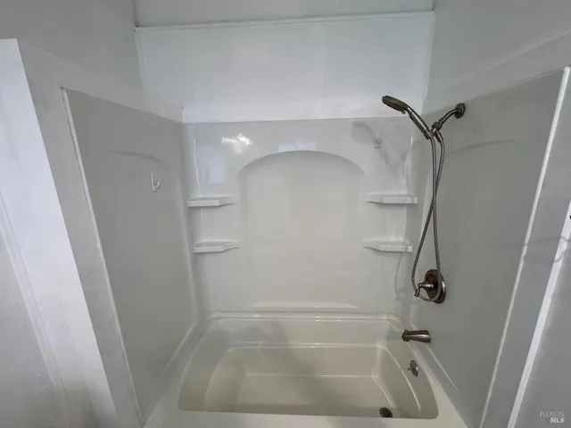 an outdoor space with patio and white umbrellas