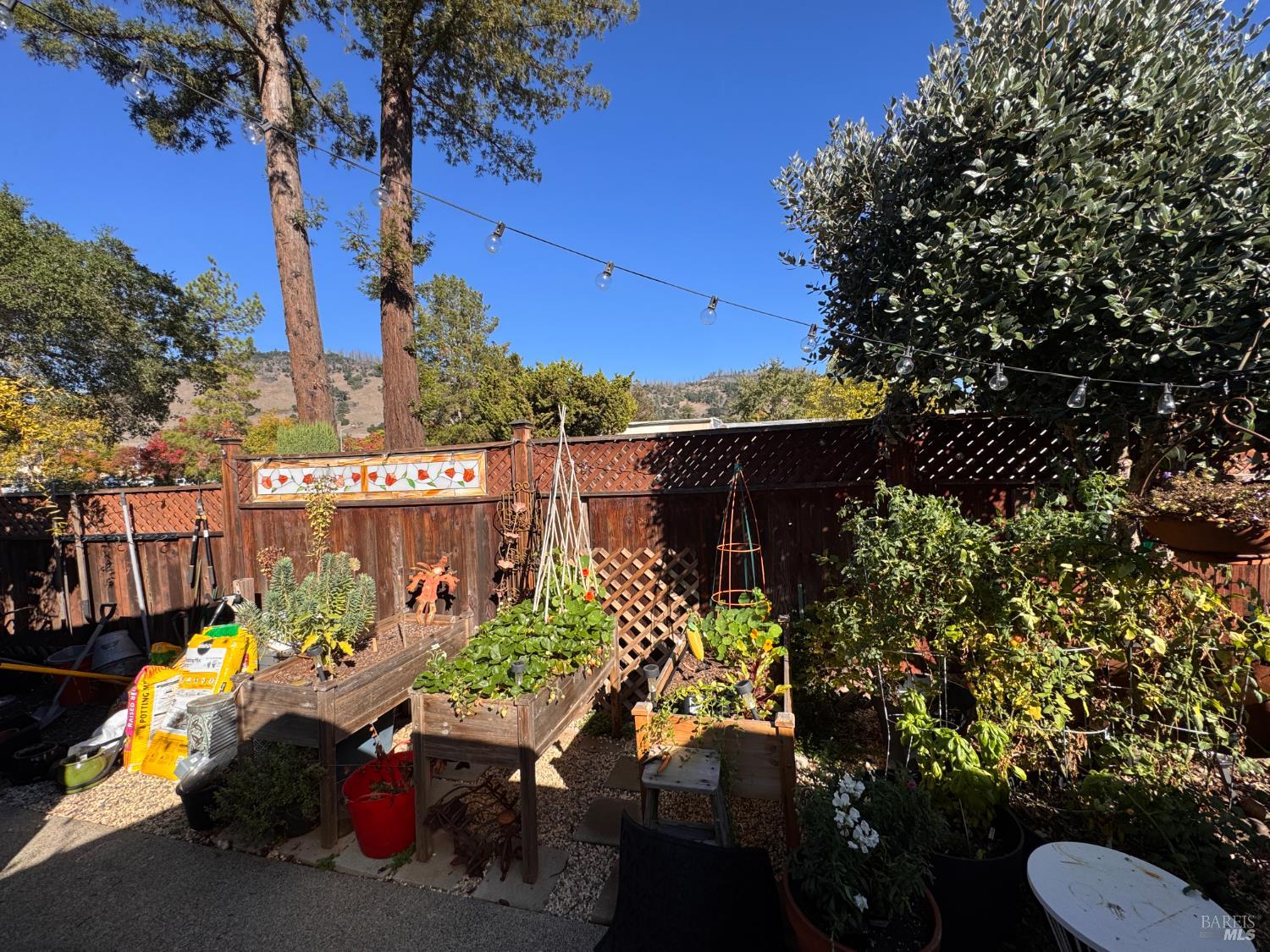 52 Oakstone Court, Unit 52 Santa Rosa, CA 95409 - Photo 30 of 49 a view of a chairs and table in a backyard