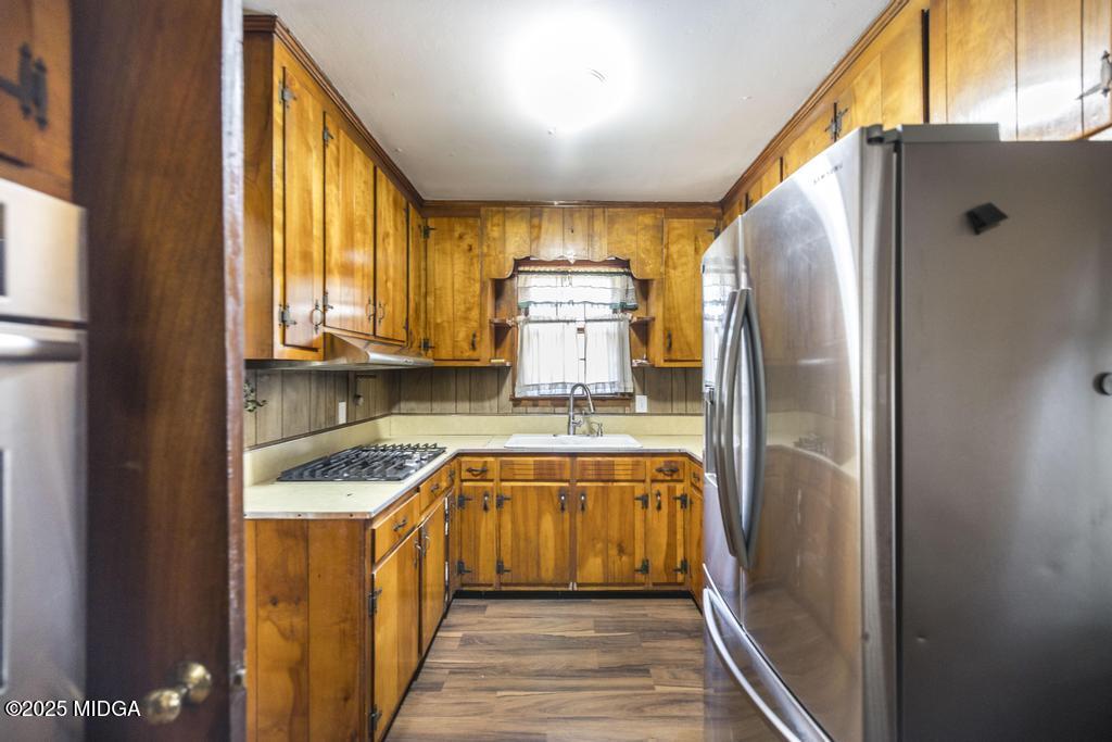1940 Manson Road Macon, GA 31217 - Photo 15 of 28 a kitchen with a refrigerator a sink and cabinets