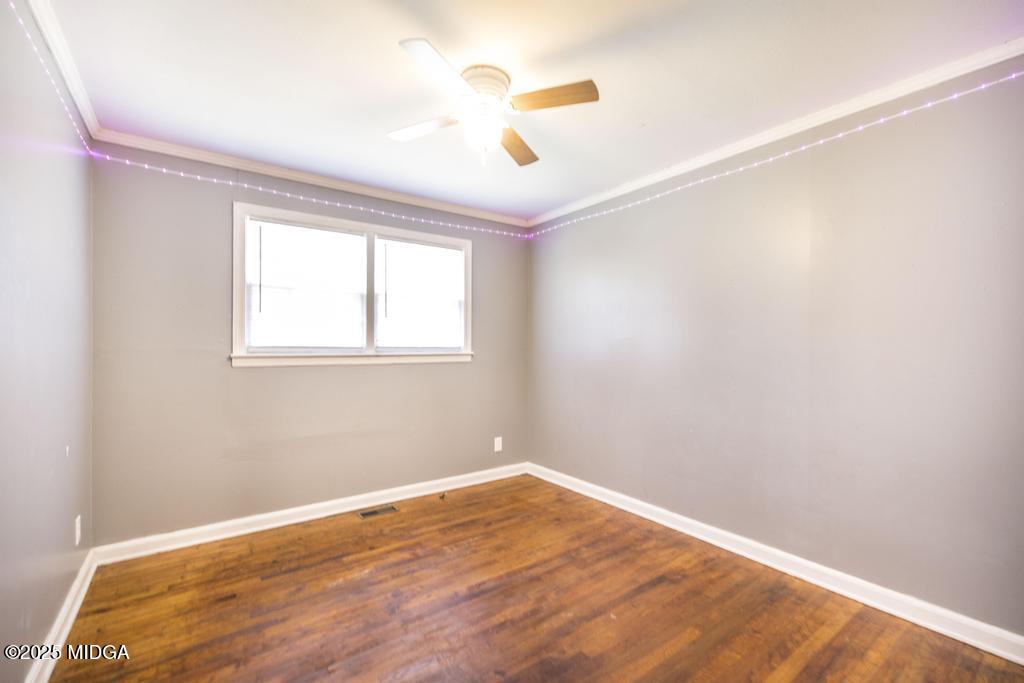 1940 Manson Road Macon, GA 31217 - Photo 18 of 28 a view of empty room with wooden floor and fan