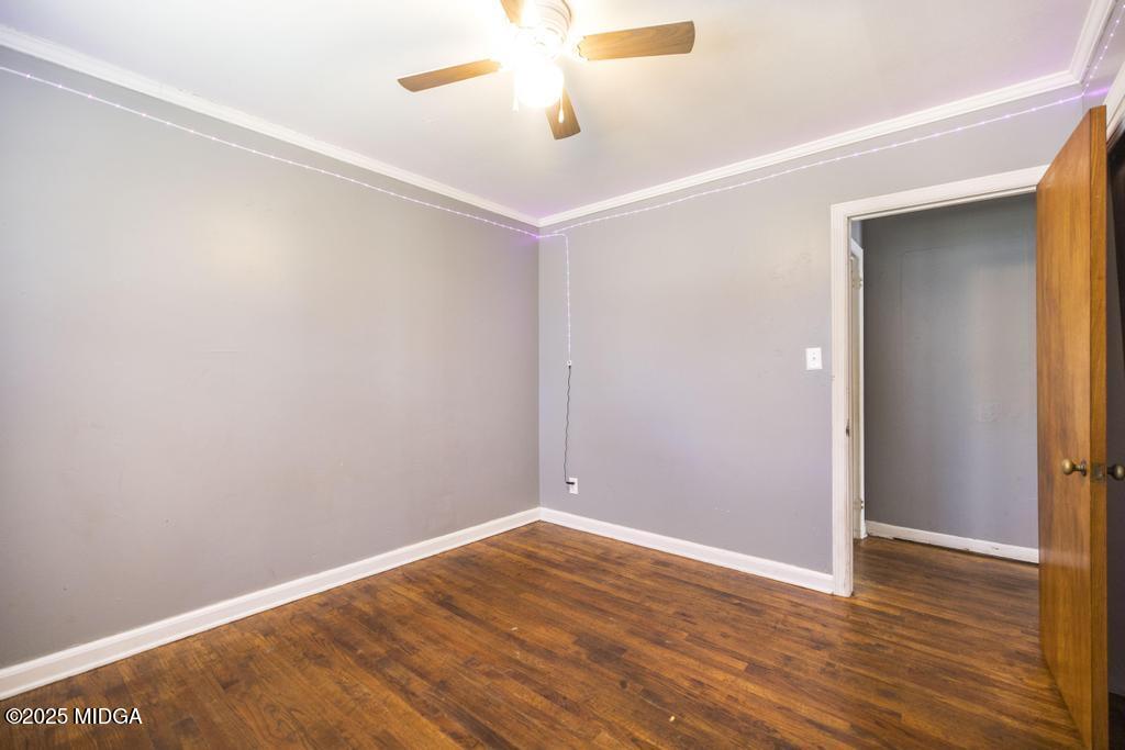 1940 Manson Road Macon, GA 31217 - Photo 19 of 28 an empty room with wooden floor and ceiling fan