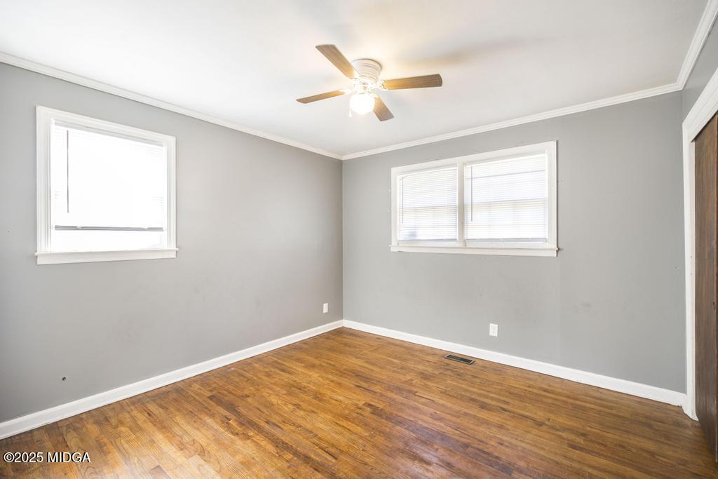 1940 Manson Road Macon, GA 31217 - Photo 20 of 28 a view of a room with wooden floor and a ceiling fan