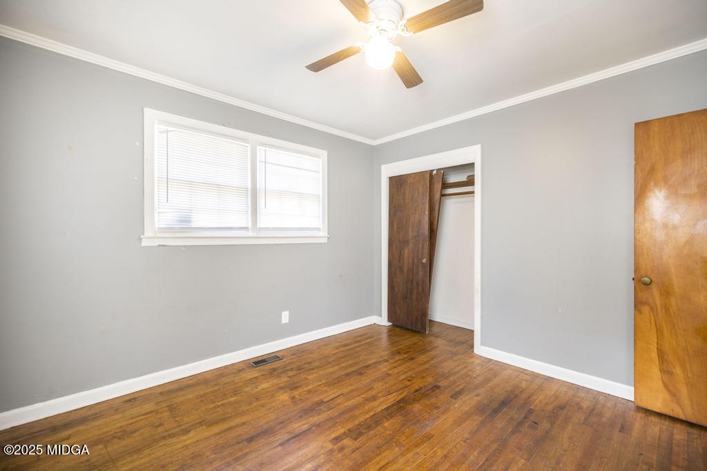 1940 Manson Road Macon, GA 31217 - Photo 21 of 28 a view of an empty room with wooden floor and a window