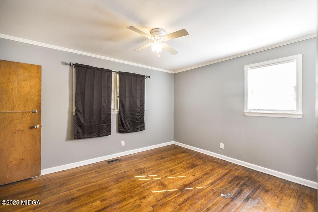 1940 Manson Road Macon, GA 31217 - Photo 23 of 28 a view of an empty room with wooden floor and a window