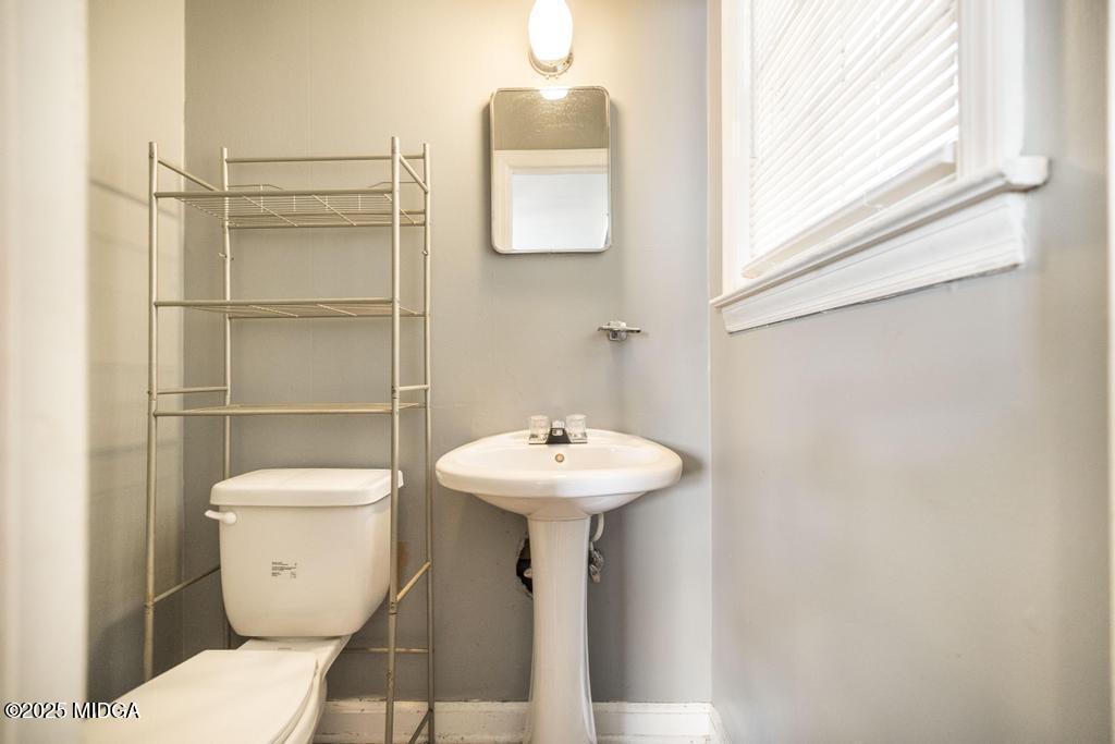 1940 Manson Road Macon, GA 31217 - Photo 25 of 28 a bathroom with a toilet sink and mirror