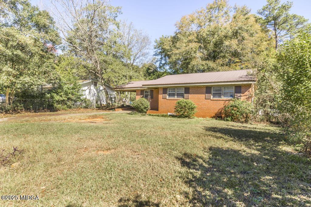 1940 Manson Road Macon, GA 31217 - Photo 3 of 28 a view of a house with backyard and trees