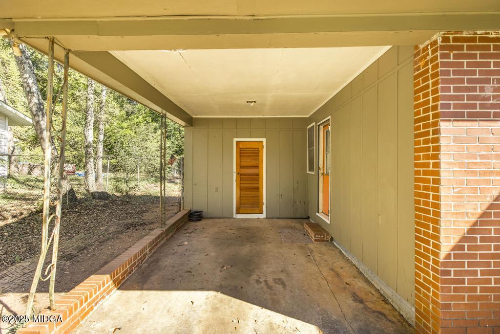 1940 Manson Road Macon, GA 31217 - Photo 5 of 28 a view of a big room with wooden floor and windows