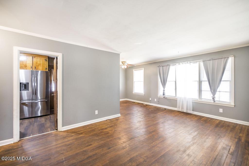 1940 Manson Road Macon, GA 31217 - Photo 9 of 28 an empty room with wooden floor and windows