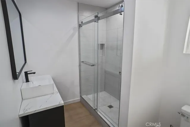 a bathroom with a shower toilet and sink