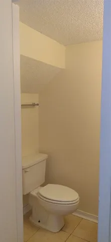 a white toilet sitting next to a shower