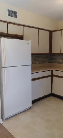 a view of a refrigerator with kitchen