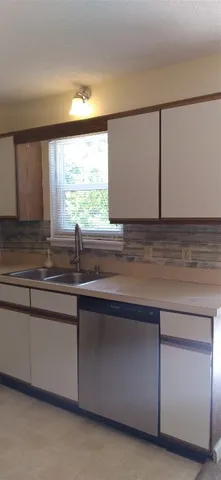 a kitchen with a sink and a window