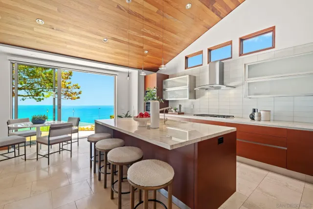 a kitchen with stainless steel appliances granite countertop a sink and a large window