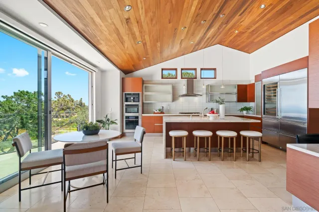 a dining hall with furniture and a potted plant