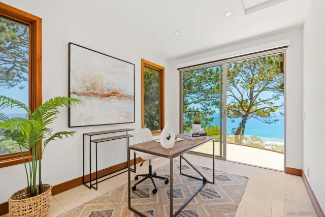 a living room with a large window and a table