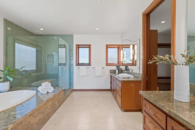 a spacious bathroom with a granite countertop sink and a mirror