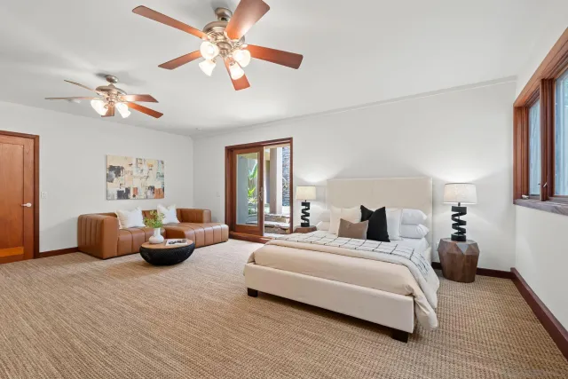 a bedroom with a large bed and a couch