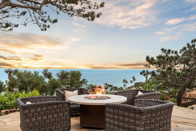 a view of a terrace with furniture and city view