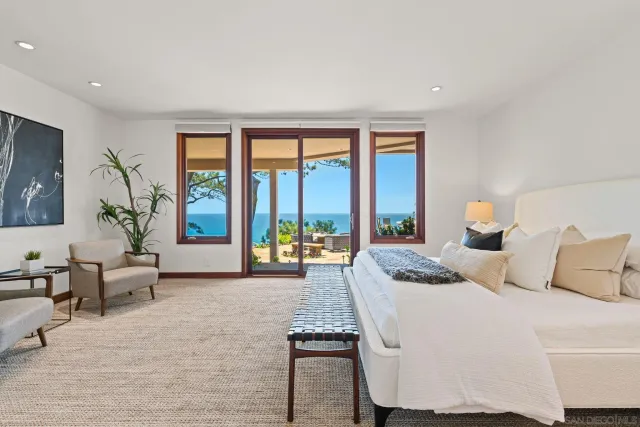 a bedroom with a large bed and a large window