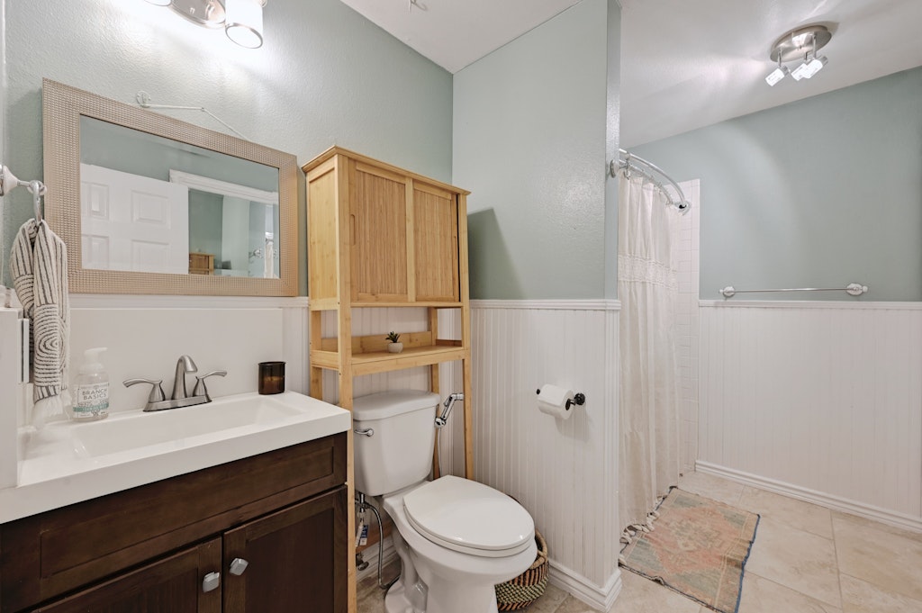 4025 Valley View Road, Unit 2 Austin, TX 78704 - Photo 16 of 19 a bathroom with a toilet sink vanity and mirror