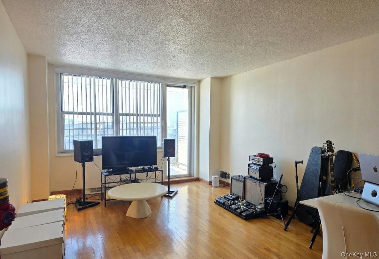 a view of a workspace with furniture and a window