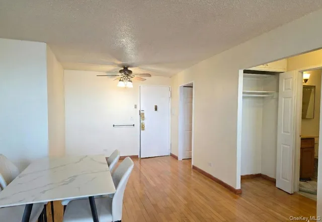 a view of a room with wooden floor table and closet
