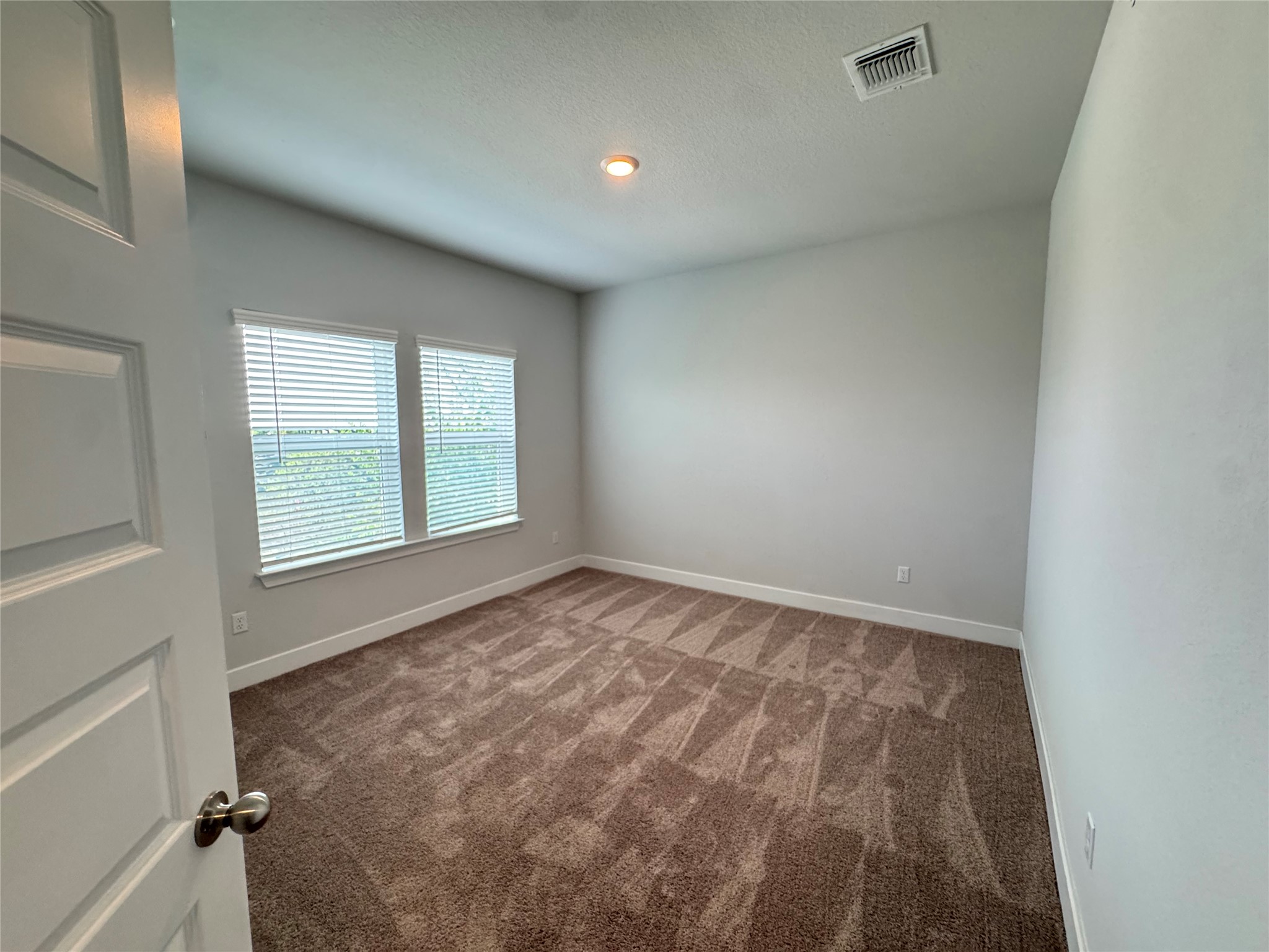 3000 Chisholm Trail Road, Unit 91 Round Rock, TX 78681 - Photo 22 of 27 An inviting room features plush carpet flooring and natural illumination through dual windows.