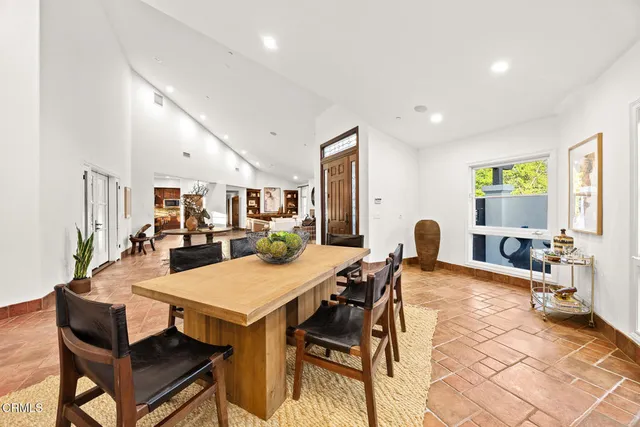 a spacious bedroom with a bed and a flat screen television