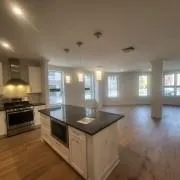 a kitchen with stainless steel appliances granite countertop a sink and a stove