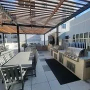 a kitchen with stainless steel appliances granite countertop a stove a sink and a wooden table