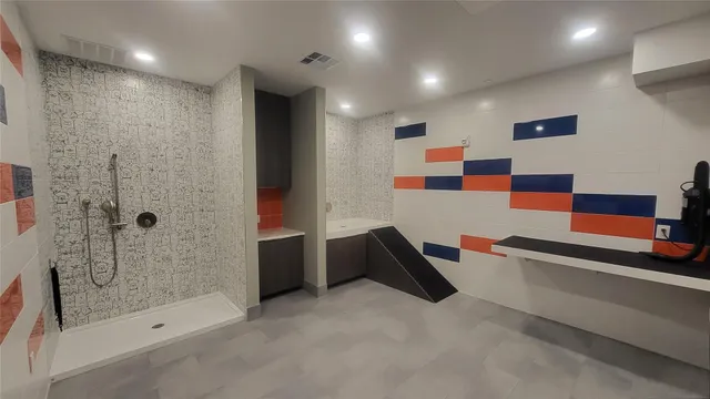a bathroom with a bathtub and a shower
