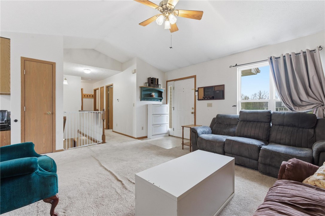 8747 Waynes Way Blanchester, OH 45107 - Photo 4 of 40 This inviting living area features vaulted ceilings and plush carpet, creating a comfortable and airy ambiance.
