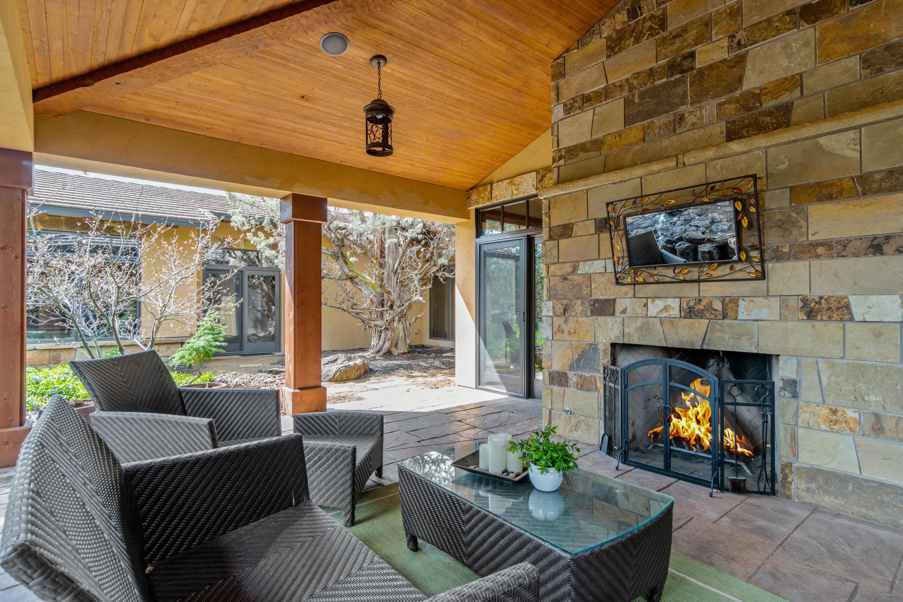 65904 Fazio Ln Bend Bend, OR 97701 - Photo 45 of 63 Multiple outdoor areas to enjoy year round including this covered patio with wood burn fireplace.