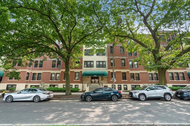 a car parked in front of a brick house