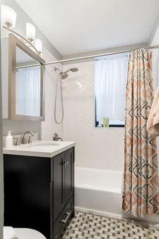 a bathroom with a bath tub a sink and a shower
