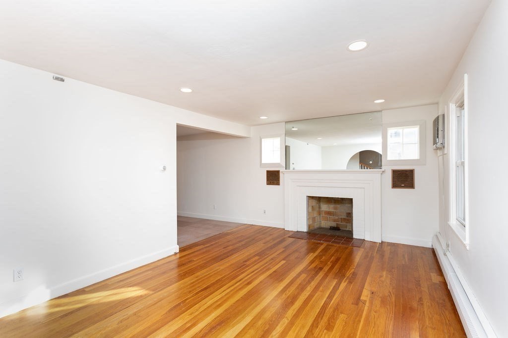 36 Intervale Road Worcester, MA 01602 - Photo 13 of 31 a view of empty room with wooden floor and fireplace