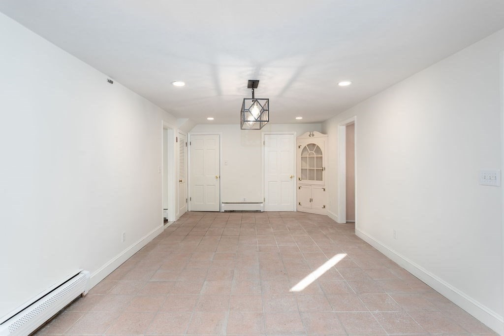 36 Intervale Road Worcester, MA 01602 - Photo 6 of 31 an empty room with kitchen and chandelier