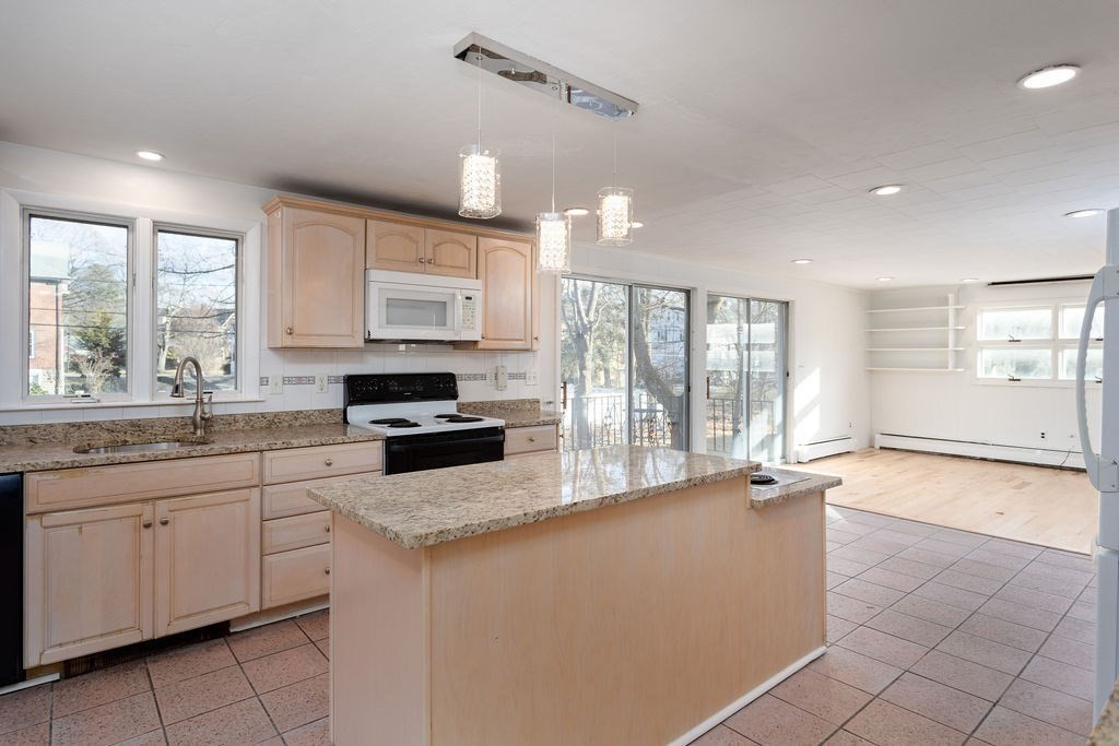 36 Intervale Road Worcester, MA 01602 - Photo 7 of 31 a large kitchen with granite countertop a stove a sink a dining table and chairs