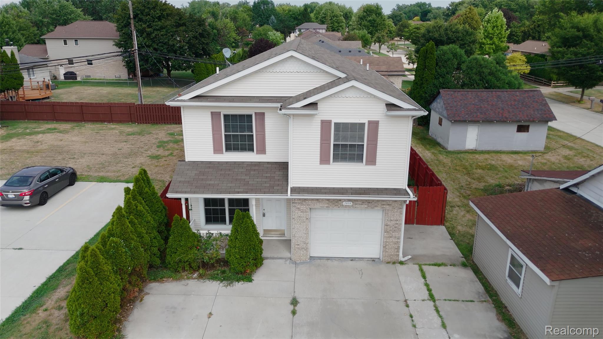 2018 John R Road Troy, MI 48083 - Photo 51 of 57 Two-story exterior with white siding and a prominent attached garage
