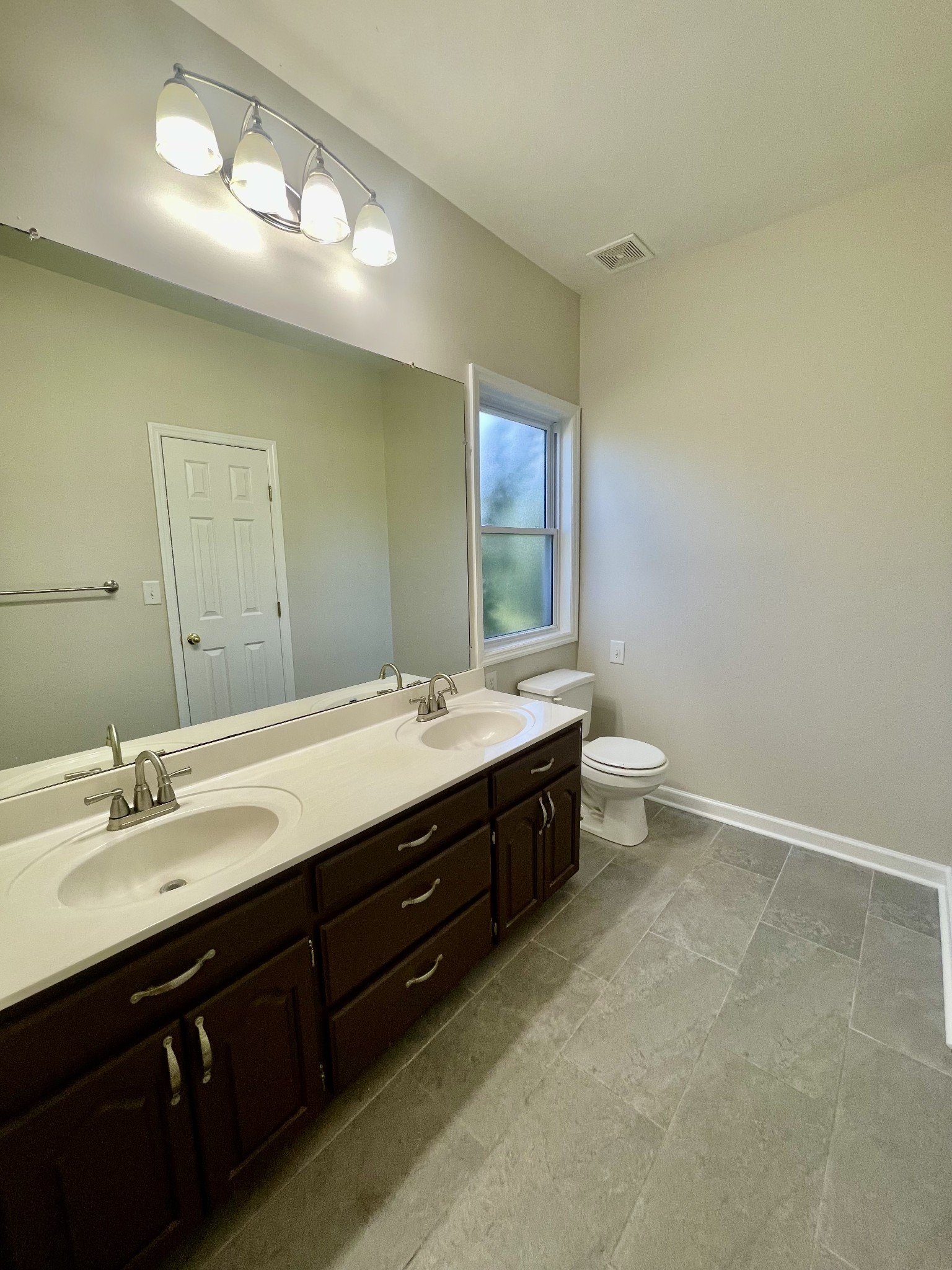 40 Harding Road Leoma, TN 38468 - Photo 17 of 35 a bathroom with a double vanity sink and a mirror