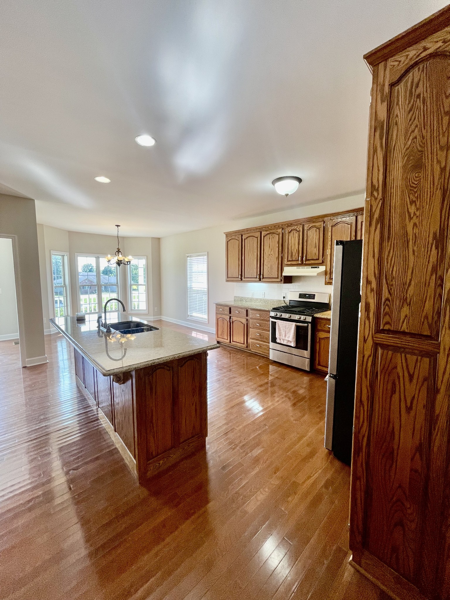 40 Harding Road Leoma, TN 38468 - Photo 7 of 35 a large kitchen with stainless steel appliances granite countertop a large counter top and wooden floors