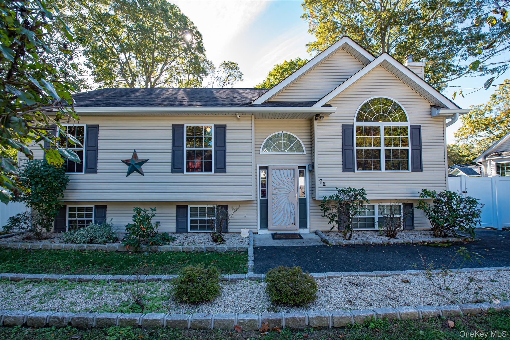 72 Clinton Avenue Mastic, NY 11950 - Photo 1 of 1 a front view of a house with garden
