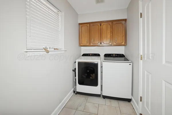 a utility room with window washer and dryer