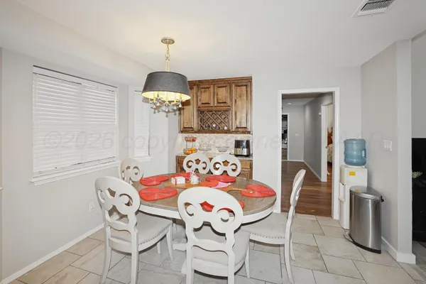 a view of a dining room with furniture wooden floor and chandelier