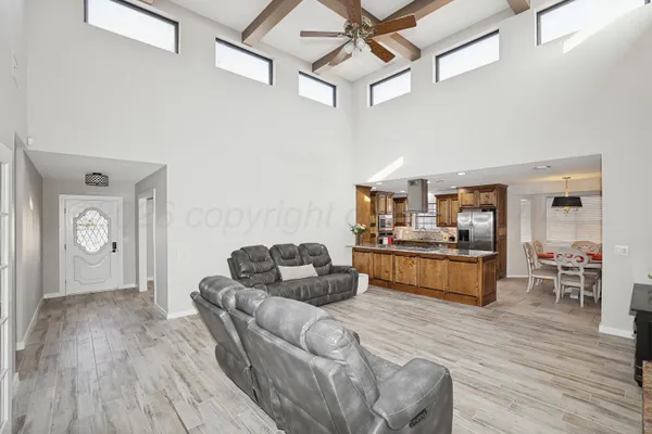 a living room with furniture and wooden floor