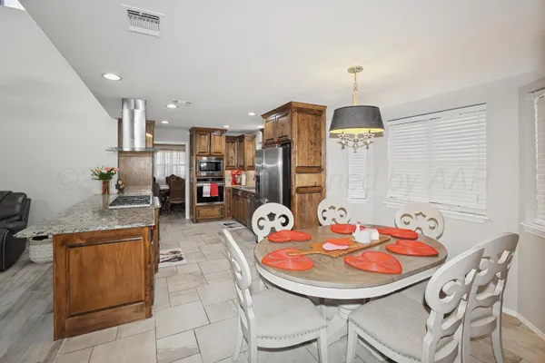 a dining room with furniture and wooden floor