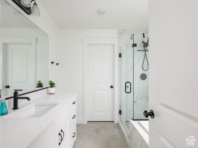 374 Ropelato Drive Nibley, UT 84321 - Photo 12 of 15 Full bathroom with vanity, a marble finish shower, marble look tile flooring, and a bathtub