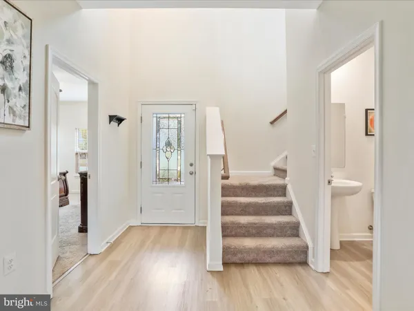 a view of an entryway with wooden floor and door